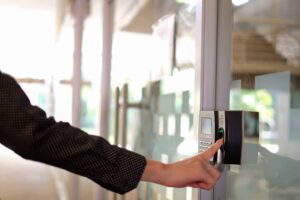 Employee Using a biometric clocking in machine